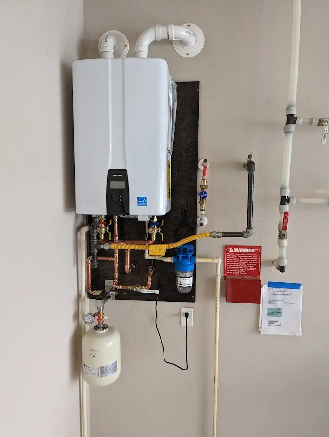 Professional plumber installing copper piping in a Hanamaulu home